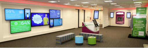 an empty showroom with ATMs, screens on the wall, and other financial institution hardware