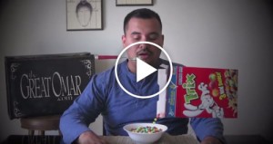 Still shot from a video of a man in a blue shirt pouring Trix cereal into a bowl at his dining room table.