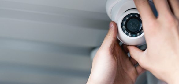 cropped-view-of-man-setting-up-security-camera-X9TA597-585x276