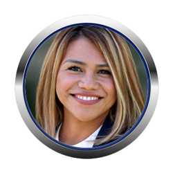 Headshot of a blonde woman smiling, wearing a dark blue blazer and white shirt